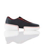 Black slip-on shoes with white platforms and red accents on a white background