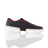 Black slip-on shoes with white platforms and red accents on a white background